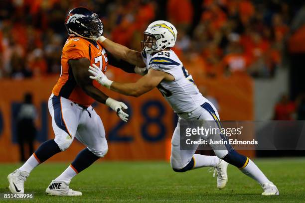 Offensive tackle Menelik Watson of the Denver Broncos defends Defensive end Joey Bosa of the Los Angeles Chargers during a game at Sports Authority...