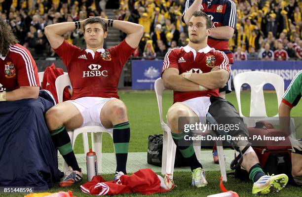 British and Irish Lions' Sam Warburton sits with an injured leg alongside team-mate Ben Youngs