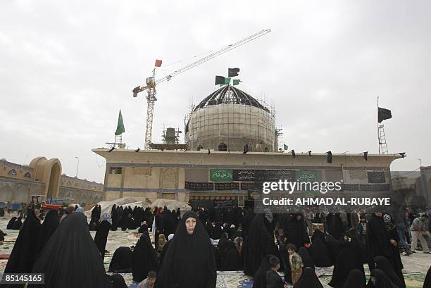 Under repair, pilgrims visit the Al-Askareyya which embraces the tombs of the 10th and 11th Imams, Ali Al-Hadi who died in 868 AD and his son Hassan...