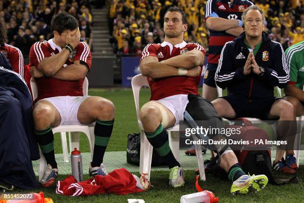 British and Irish Lions' Ben Youngs, Sam Warburton and conditioning coach Paul Stridgeon watch from the bench during the Second Test match at the...