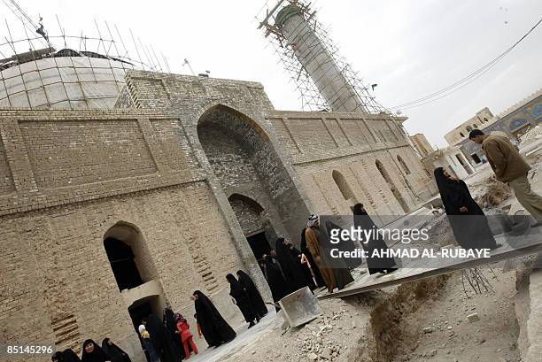 Under repair, pilgrims visit the al-Askareyya Shrine which embraces the tombs of the 10th and 11th Imams, Ali Al-Hadi and his son Hassan Al-Askari in...