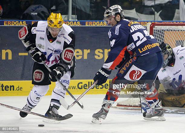 Sebastian Osterloh of Frankfurt battles for the puck with Andre Rankel of Berlin during the DEL Bundesliga match between EHC Eisbaeren Berlin and...