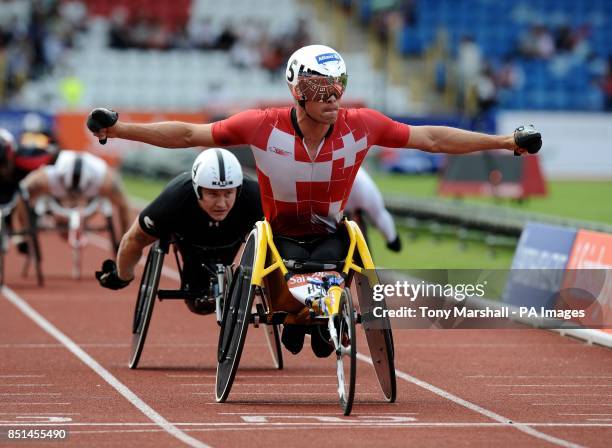 Switzerland's Marcel Hug wins the 500m Men - T54 race ahead of Great Britain's David Weir during The Sainsbury's IPC Grand Prix Final during day one...