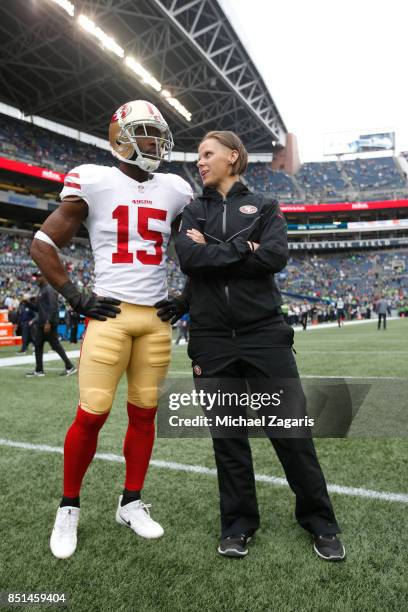 Pierre Garcon and Offensive Assistant Coach Katie Sowers of the San Francisco 49ers talk on the field prior to the game against the Seattle Seahawks...