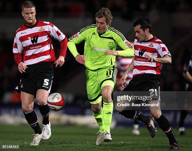 Rob Hulse of Derby is challenged by Sam Hurd of Doncaster during the Coca-Cola Championship match between Doncaster Rovers and Derby County at the...