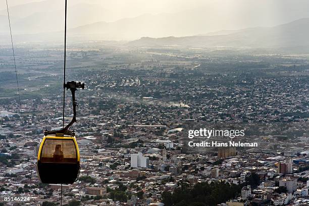 one woman in a cable gondola over salta, argentina - salta argentina stock pictures, royalty-free photos & images