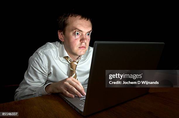 worn out man behind computer at night - staring stock pictures, royalty-free photos & images