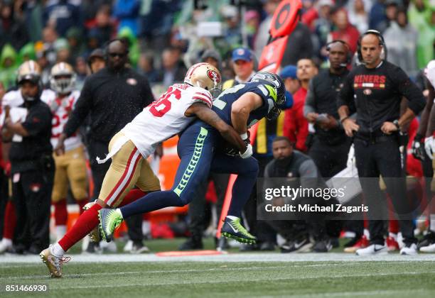 Dontae Johnson of the San Francisco 49ers tackles Luke Willson of the Seattle Seahawks during the game at CenturyLink Field on September 17, 2017 in...