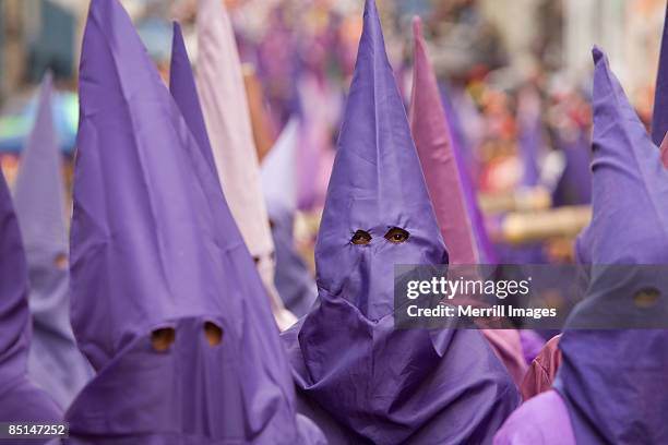 men wearing purple hooded costume for holy week - quito stock-fotos und bilder