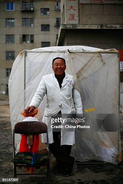 Street barber Zhang Wenge poses for a photo outside his plastic shelter street-side stand, on February 26, 2009 in Changchun of Jilin Province,...