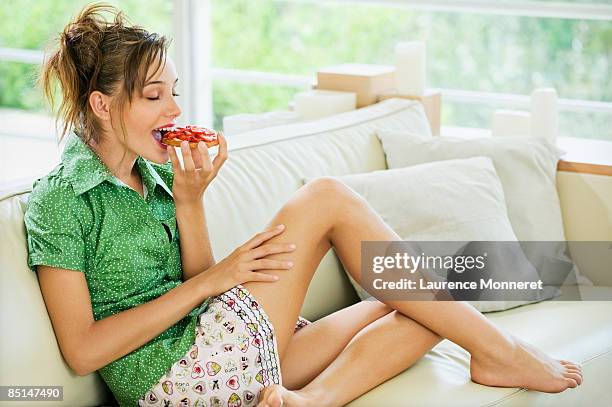 slender woman eyes closed eating a strawberry pie - skinny teen ス�トックフォトと画像