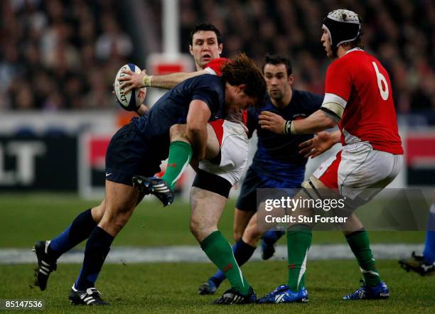 Wales fly half Stephen Jones is tackled by France hooker Dimitri Szarzewski during the RBS 6 Nations game between France and Wales at Saint Denis on...