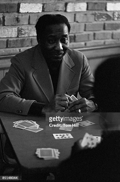 American Blues legend Muddy Waters plays cards with his band members backstage at Richards' Rock Club on May 29, 1972 in Atlanta, Georgia.