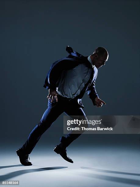 businessman in suit walking against strong wind - businessman challenge stock pictures, royalty-free photos & images