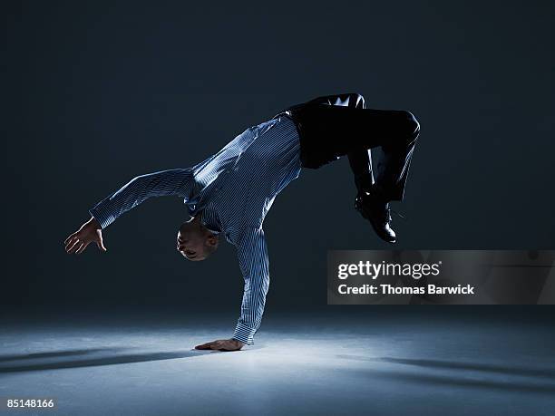 businessman flipping over backwards - agility studio shot stock pictures, royalty-free photos & images