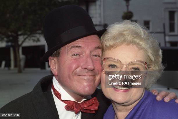 Lois Laurel, daughter of comedian Stan Laurel, poses with entertainer Roy Castle, who is dressed as her famous father. They were promoting the video...