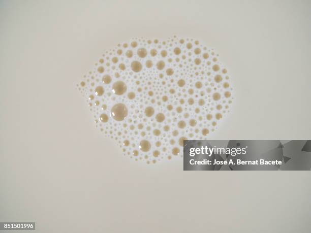 full frame of abstract shapes and textures formed on a white liquid background - milk full frame stock pictures, royalty-free photos & images