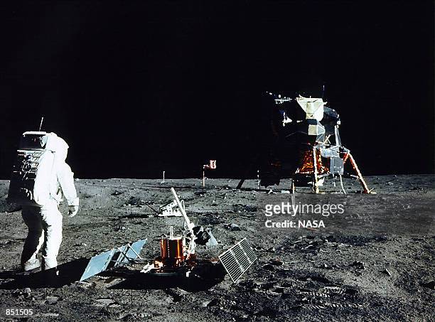 Astronaut Edwin E. Aldrin Jr., Lunar Module Pilot, stands near a scientific experiment on the lunar surface. Man's first landing on the Moon occurred...