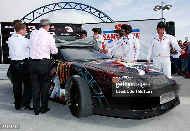 Elvis impersonators pose during practice for the NASCAR Sprint Cup Series Shelby 427 at the Las Vegas Motor Speedway on February 27, 2009 in Las...