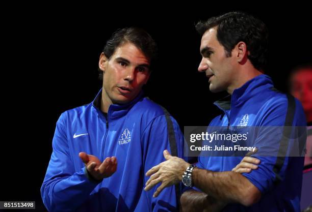 Rafael Nadal and Roger Federer of Team Europe watch the singles match between Dominic Thiem of Team Europe and John Isner of Team World on the first...