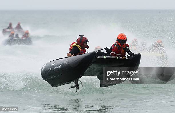 Greg Powell and Sarah Barrell of the Waikato Sandblasting thunder cat ride a wave during round six of the Surf Cross National series at Piha Beach on...