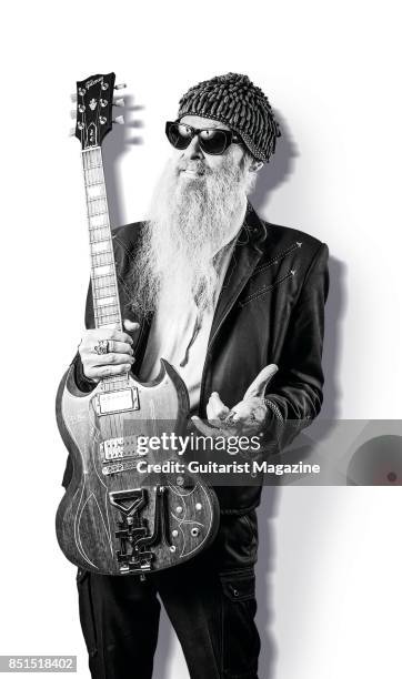 Portrait of American musician Billy Gibbons, photographed with his Gibson '61 Reissue Les Paul SG electric guitar backstage at Notodden Blues...