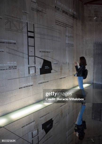 Visiting journalist seen observing a diagram of Pier 7 of 25 de Abril bridge, site of the "Experiencia Pilar 7" an interpretive center of the bridge...