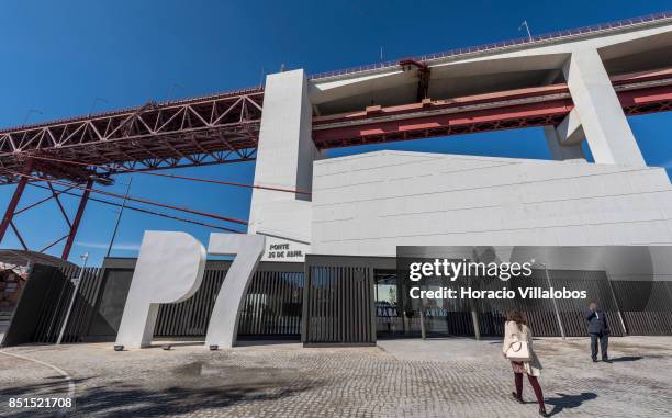 Visiting journalist walks to the entrance of Pier 7 of 25 de Abril bridge, site of the "Experiencia Pilar 7" an interpretive center of the bridge...