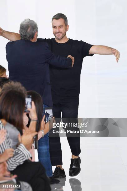 Designers Roberto Cavalli and Paul Surridge acknowledge the applause of the audience at the Roberto Cavalli show during Milan Fashion Week...