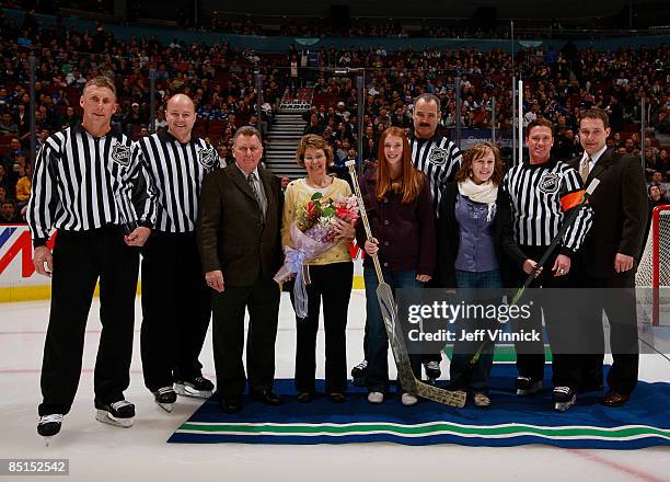 Linesman Brad Lazarowich is honoured for officiating his 1500th NHL game with family and fellow officials Kelly Sutherland, Don VanMassenhoven and...