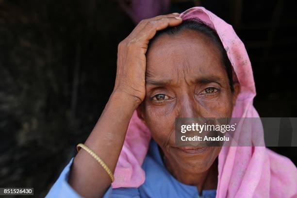 Rohingya Muslim woman, fled from ongoing military operations in Myanmars Rakhine state, poses for a photograph at a makeshift camp in Teknaff,...