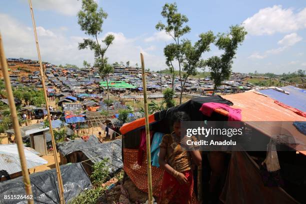 Rohingya Muslim girl, fled from ongoing military operations in Myanmars Rakhine state, poses for a photograph near a tent at a makeshift camp in...