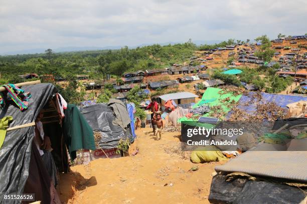 Rohingya Muslims, fled from ongoing military operations in Myanmars Rakhine state, are seen near a tent at a makeshift camp in Teknaff, Bangladesh on...