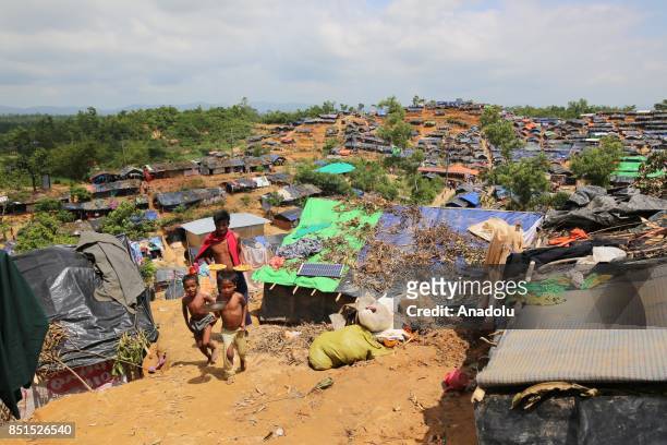 Rohingya Muslims, fled from ongoing military operations in Myanmars Rakhine state, are seen near a tent at a makeshift camp in Teknaff, Bangladesh on...