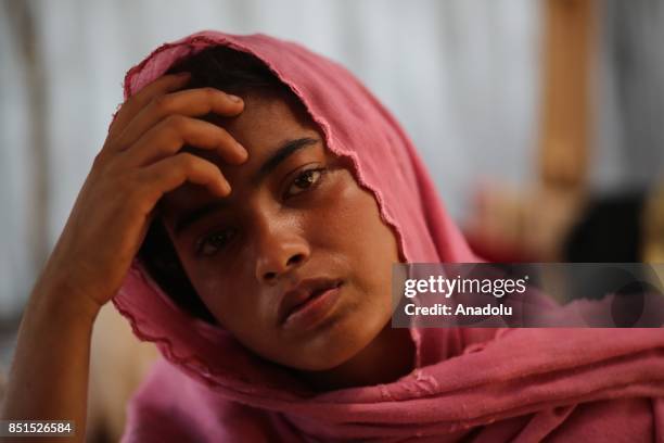 Rohingya Muslim woman, fled from ongoing military operations in Myanmars Rakhine state, poses for a photograph in a tent at a makeshift camp in...