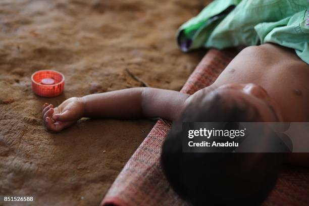 Rohingya Muslim baby, fled from ongoing military operations in Myanmars Rakhine state, lies down in a tent at a makeshift camp in Teknaff, Bangladesh...
