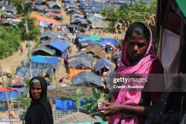 Rohingya Muslim women, fled from ongoing military operations in Myanmars Rakhine state, pose for a photograph near a tent at a makeshift camp in...