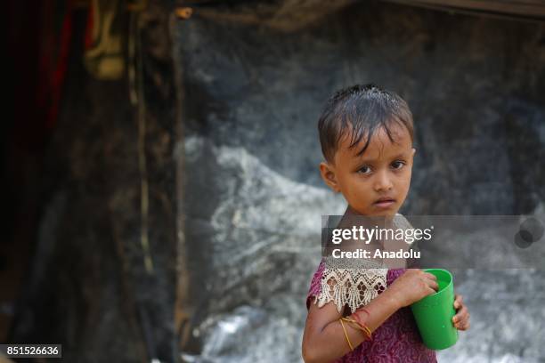 Rohingya Muslim child, fled from ongoing military operations in Myanmars Rakhine state, poses for a photograph near a tent at a makeshift camp in...