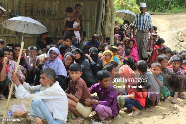 Rohingya Muslims, fled from ongoing military operations in Myanmars Rakhine state, sit on the ground at a makeshift camp in Teknaff, Bangladesh on...