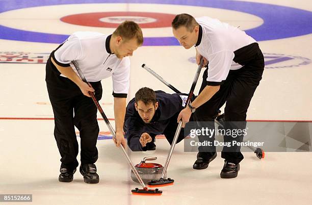 Jason Smith delivers a rock as Jeff Isaacson and John Benton sweep for Team John Shuster's in their men's semi final match against Team Todd Birr in...