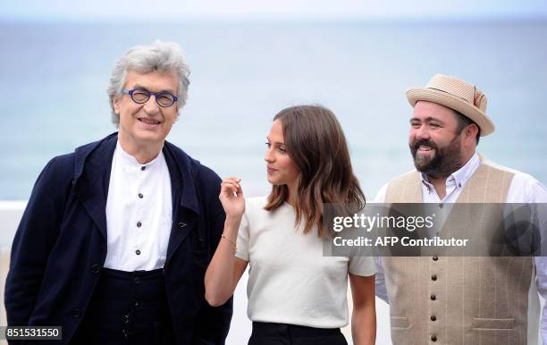 Film director Wim Wenders from Germany , actress Alicia Vikander from Sweden and actor Celyn Jones from Wales pose during a photocall to promote...