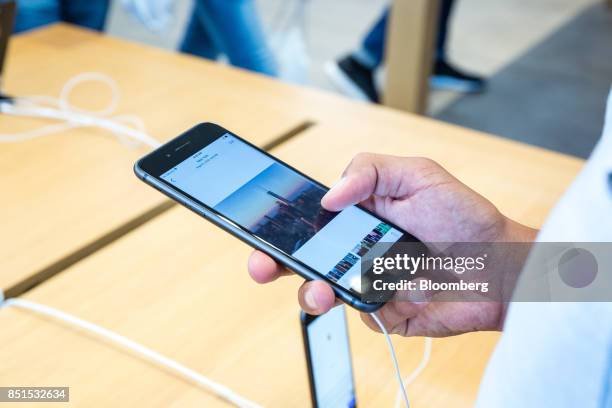 Customer views an Apple Inc. IPhone 8 smartphone during the sales launch of the Apple Inc. IPhone 8 smartphone, Apple watch series 3 device, and...