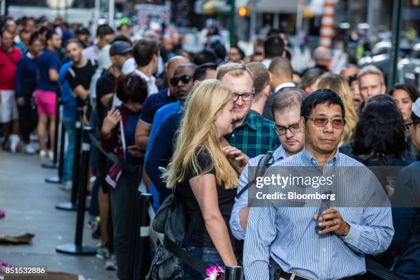 Customers stand in line during the sales launch of the Apple Inc. IPhone 8 smartphone, Apple watch series 3 device, and Apple TV 4K outside a store...