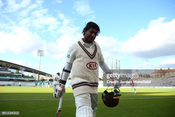 Kumar Sangakkara of Surrey leaves the field in his final home game for Surrey after being caught and bowled by Dominic Bess of Somerset during day...