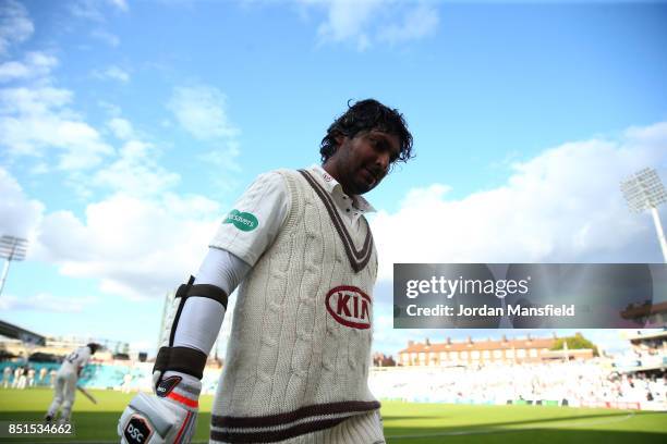 Kumar Sangakkara of Surrey leaves the field in his final home game for Surrey after being caught and bowled by Dominic Bess of Somerset during day...