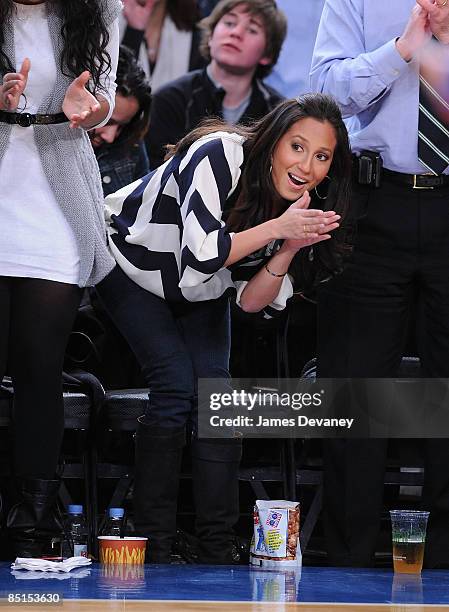 Adrienne Bailon and guest attend Philadelphia 76ers vs New York Knicks game at Madison Square Garden on February 27, 2009 in New York City.