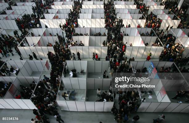 Job seekers visit a job fair for graduating university students at the Qujiang International Convention and Exhibition Center on February 28, 2009 in...