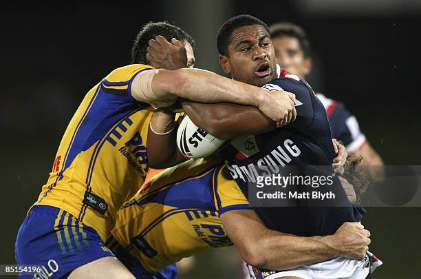 Lopini Paea of the Roosters is tackled during the NRL Trial match between the Parramatta Eels and the Sydney Roosters at Campbelltown Sports Stadium...