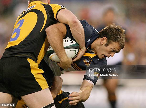 Julian Salvi of the Brumbies is tackled during the round three Super 14 match between the Brumbies and the Western Force at Canberra Stadium on...