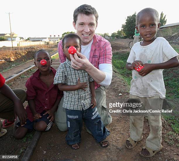 Presenter Ben Shephard meets street children on February 26, 2009 in Moshi Tanzania. The presenter is in the region for Sunday's BT Red Nose Climb of...